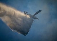 First official report on wildfire, large explosion at central Greece airbase expected on Wed.