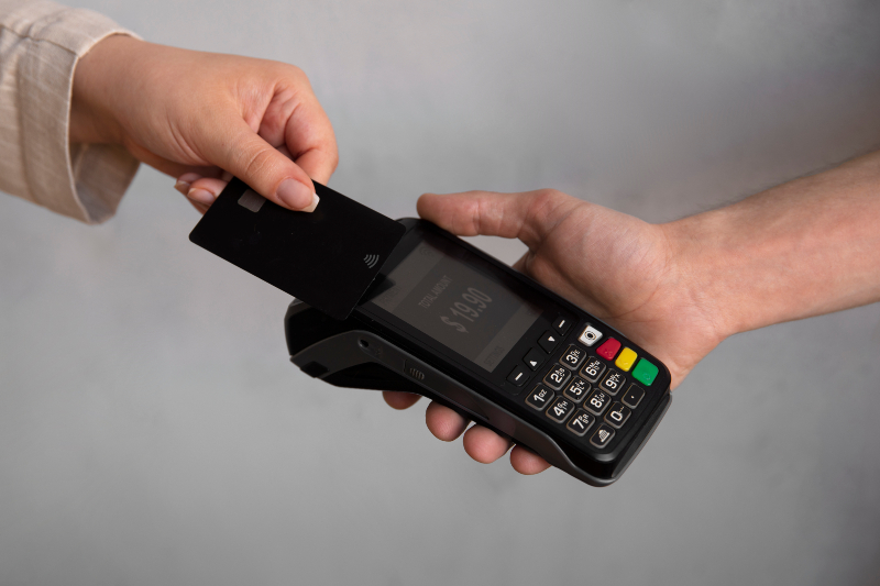 high angle customer paying with nfc device 2